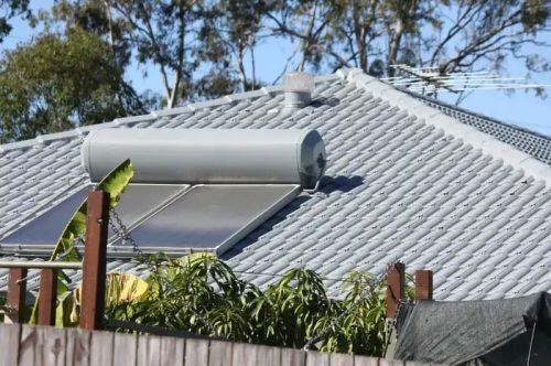 Image of a tile house roof with a solar hot water system installed on the roof